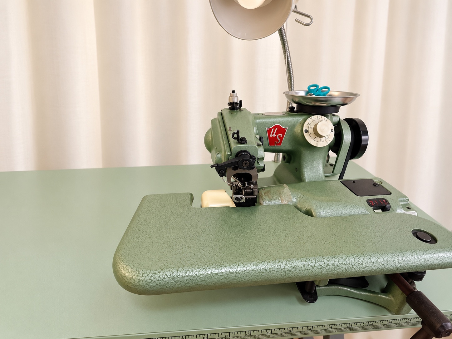 Green specialty sewing machine and task lamp.