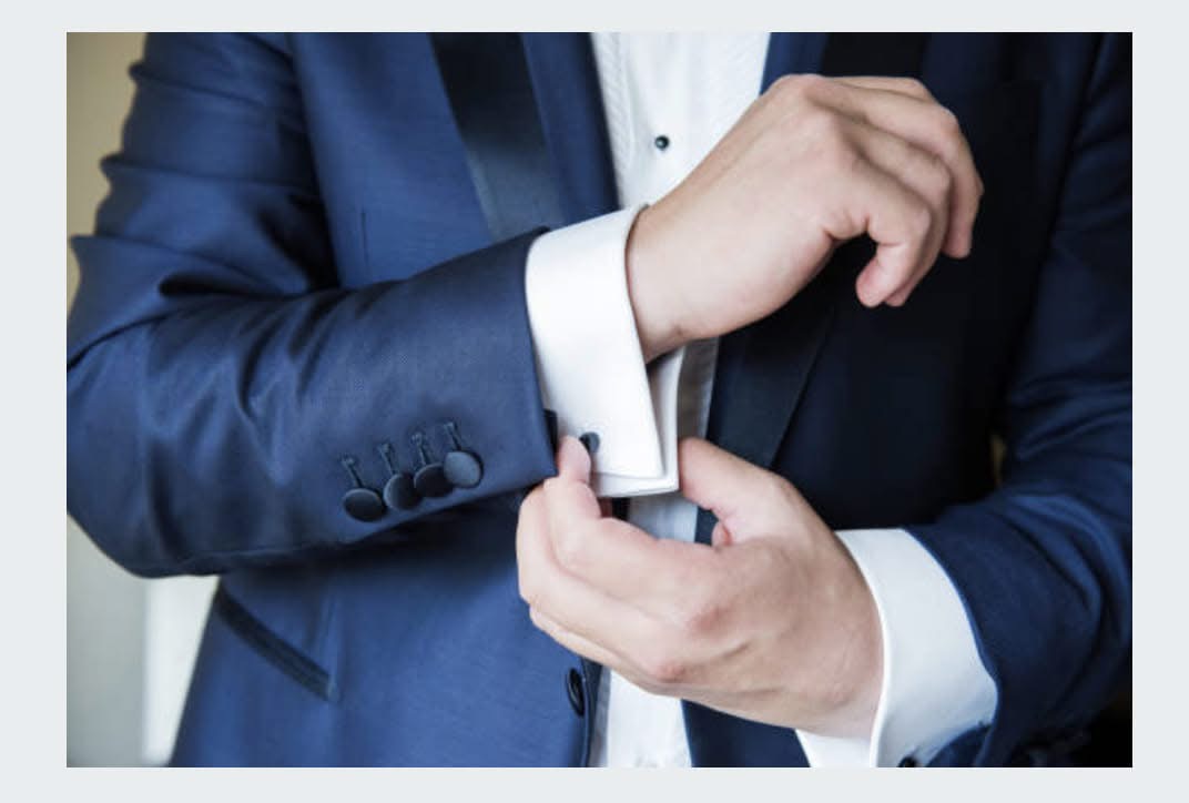 Blue suit and white shirt cuff.