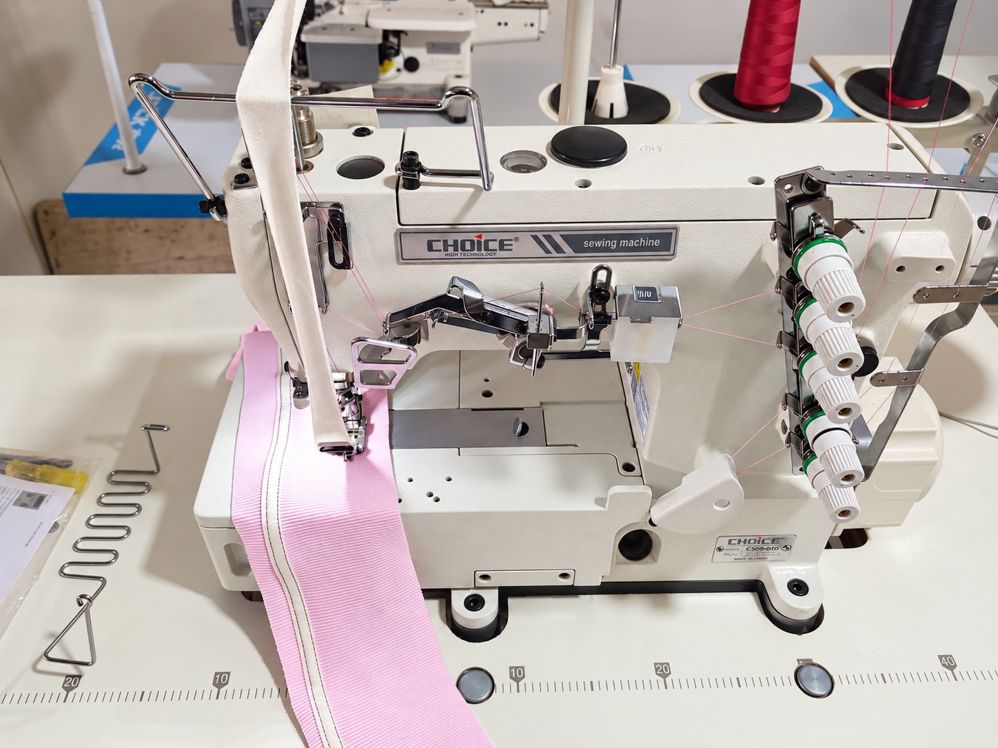 Specialized sewing machine with several thread cones.