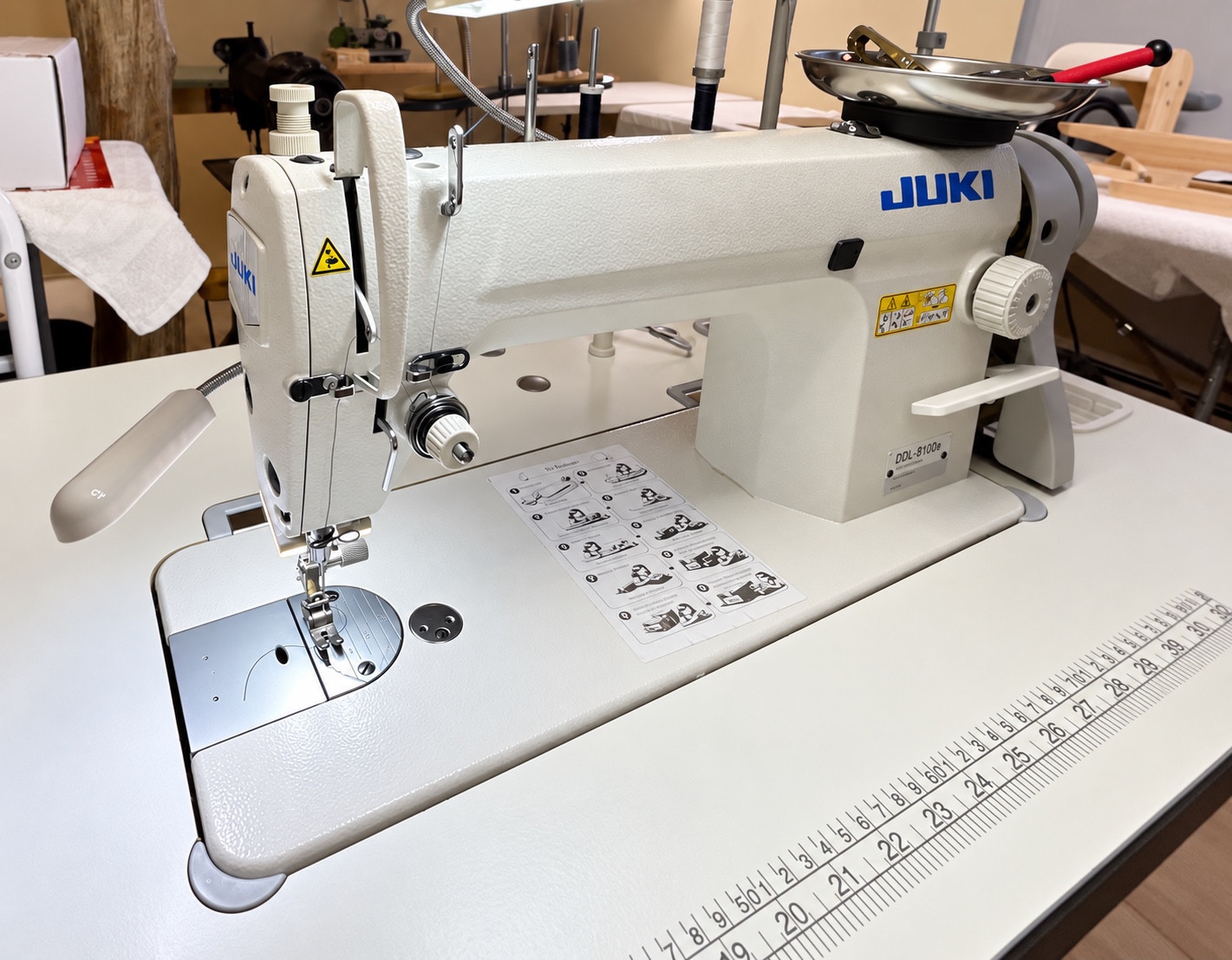 Industrial Juki sewing machine at a worktable.