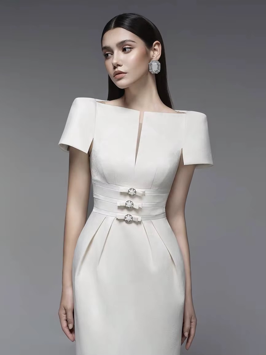 Ivory dress with structured sleeves.