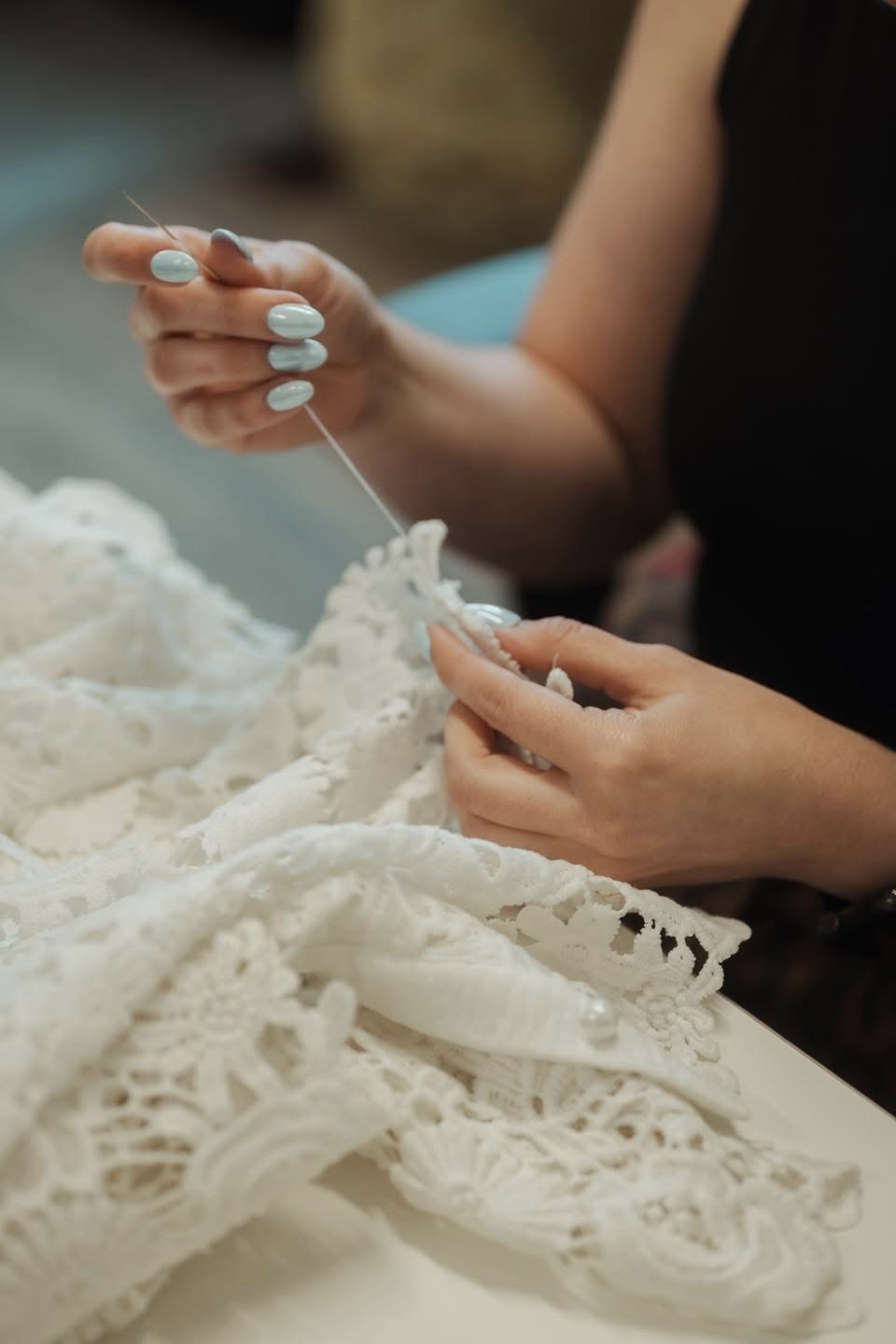 Hand stitching on ivory lace.