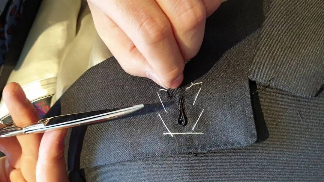 Close-up of tailoring work at a buttonhole.